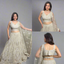 Elegant ivory lehenga set with intricate embroidery, delicate tassels.