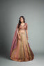 lehenga draped in earthy tones of olive and rose gold