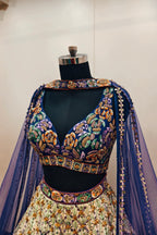 Luxurious Multi-Toned Lehenga with Cream Base and Elegant Purple Net Dupatta - Designer Ethnic Masterpiece