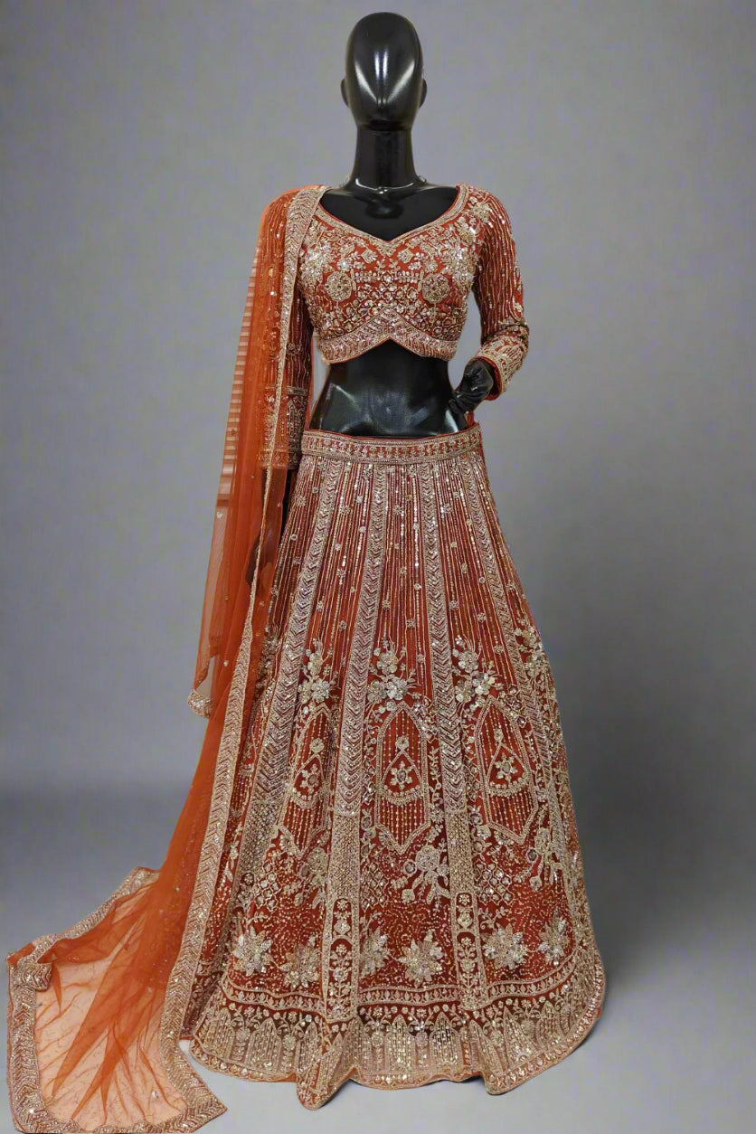 Elegant rust-orange bridal lehenga with intricate golden embroidery