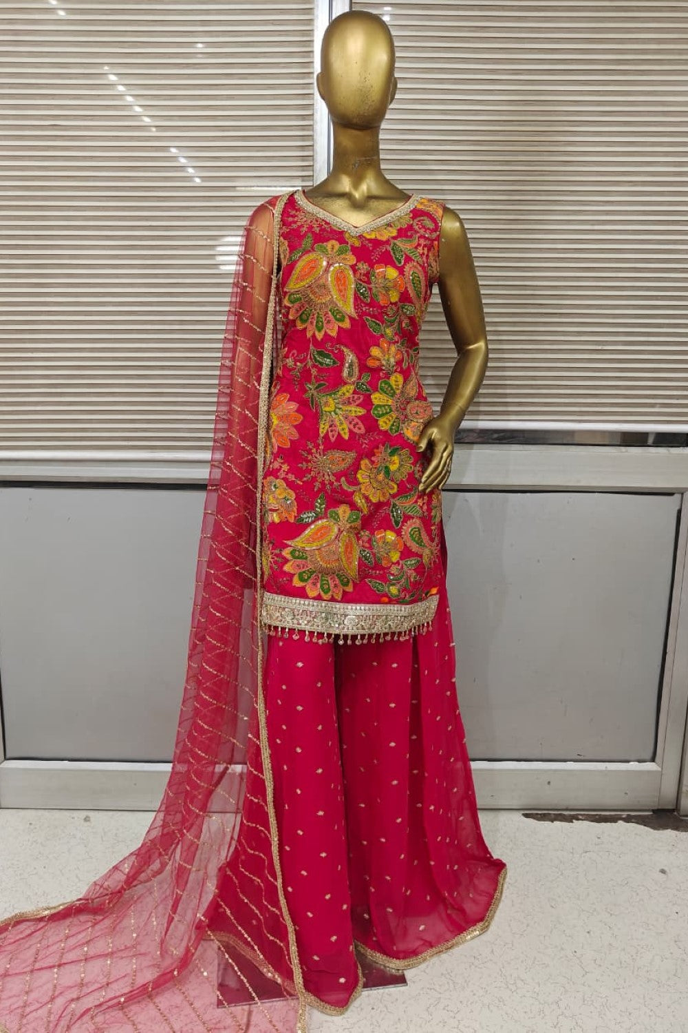 Stunning bright pink Punjabi suit featuring heavy floral embroidery