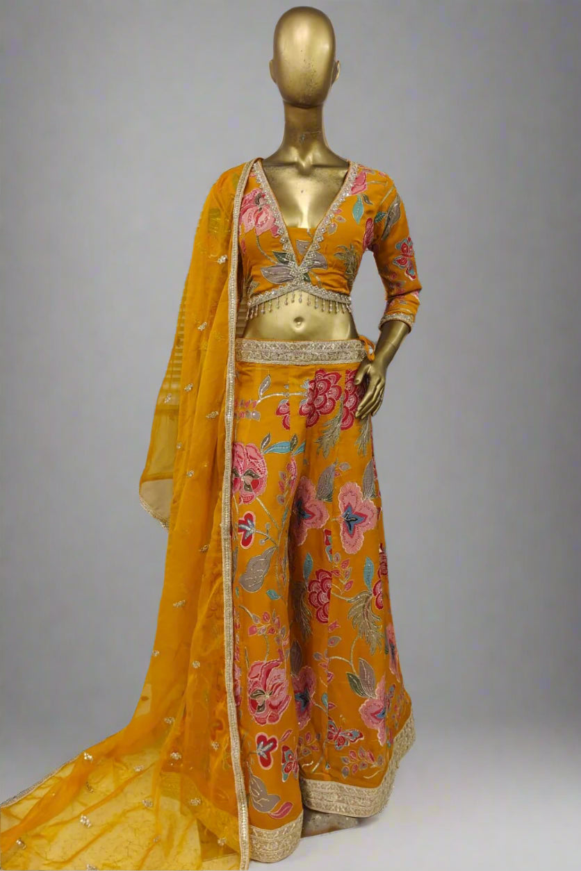 Bright pink embroidered plazzo outfit with bold floral motifs