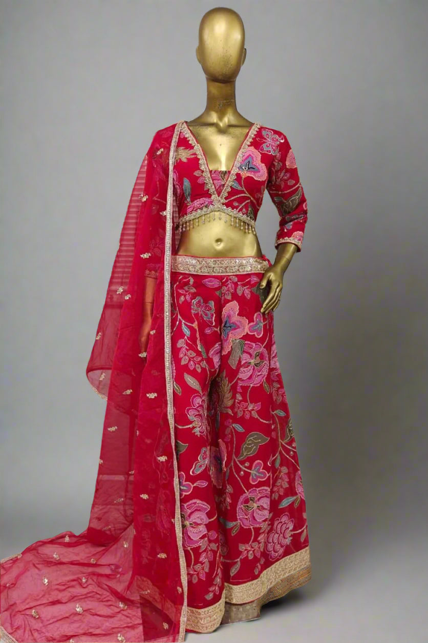 Bright pink embroidered plazzo outfit with bold floral motifs