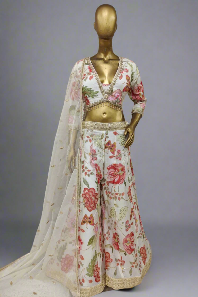 Bright pink embroidered plazzo outfit with bold floral motifs