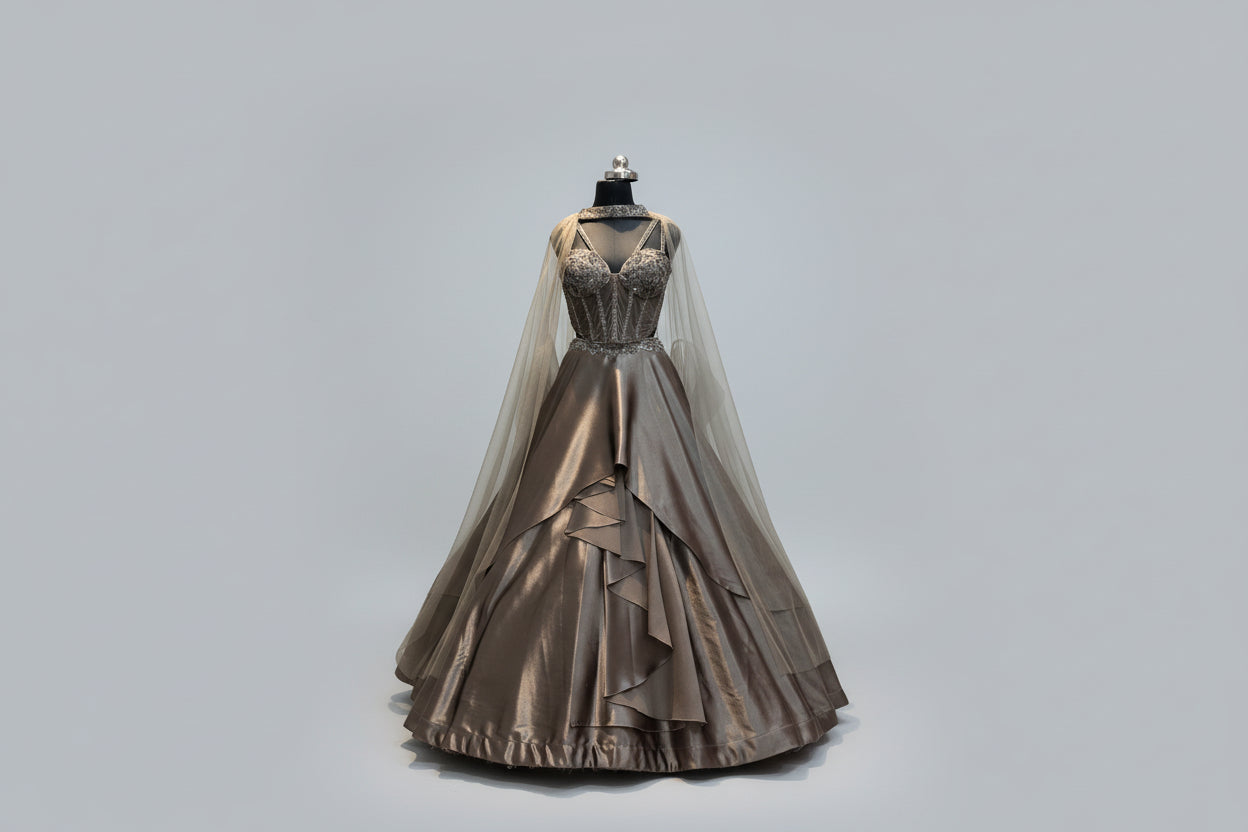 Ethereal bronze ball gown with embellished corset and cape. Main image