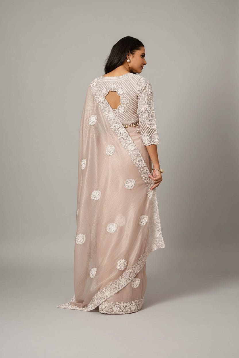 Graceful blush saree adorned with timeless white embroidery.