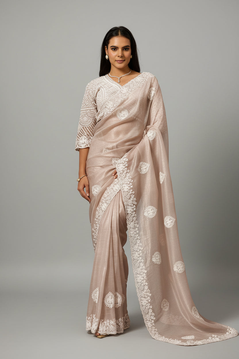Graceful blush saree adorned with timeless white embroidery.
