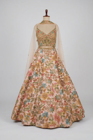 Blush pink floral lehenga featuring vibrant botanical prints