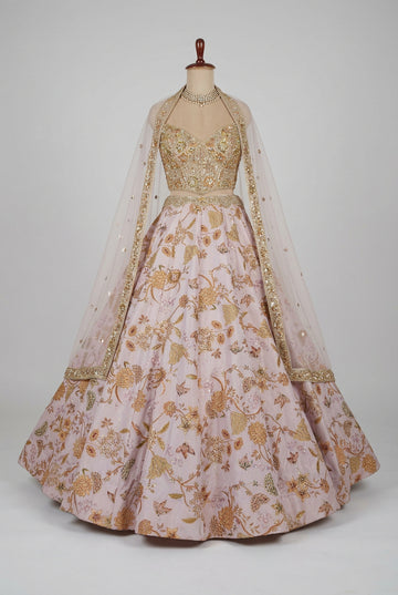Elegant blush pink lehenga featuring exquisite gold floral embroidery