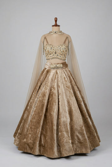 Luxurious champagne-gold velvet lehenga adorned with intricate embellishments