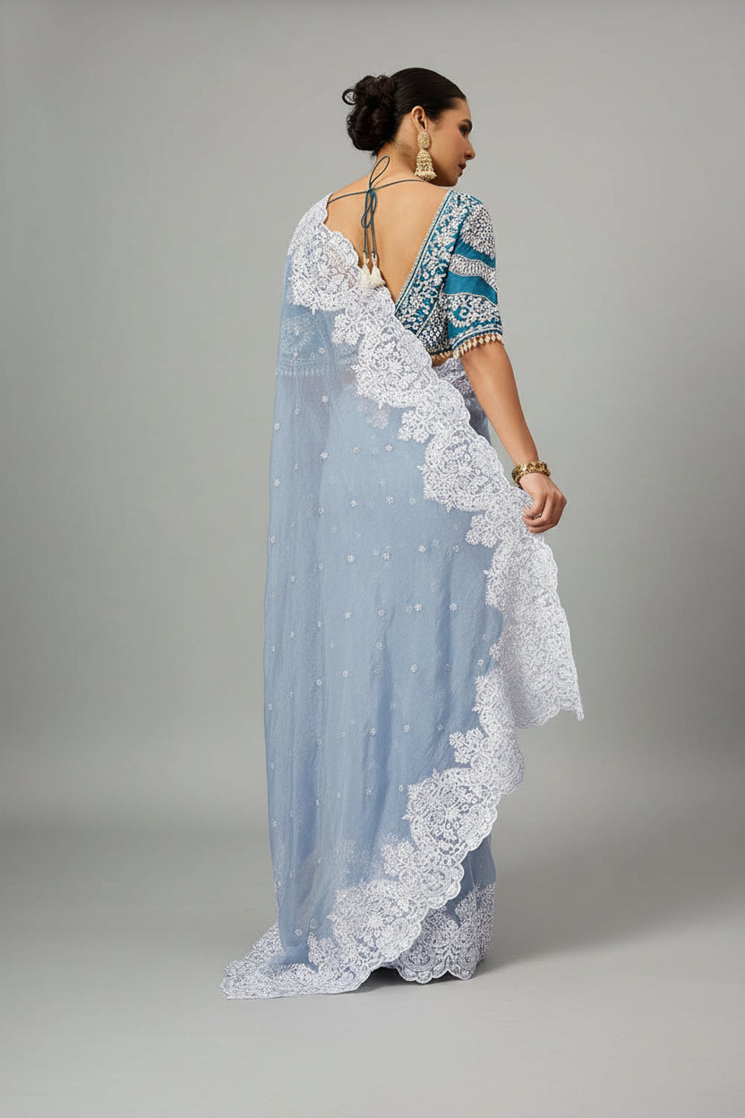 Powder blue saree adorned with exquisite white embroidery