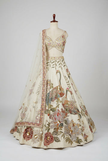 Elegant ivory bridal lehenga featuring intricate peacock embroidery