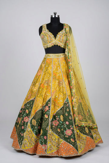 Vibrant yellow and emerald green lehenga featuring intricate mirror work