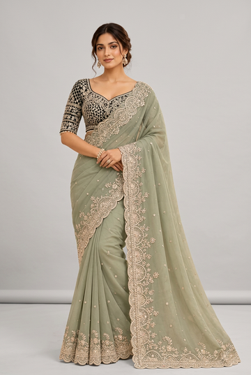 Elegant sage-green saree featuring intricate champagne embroidery