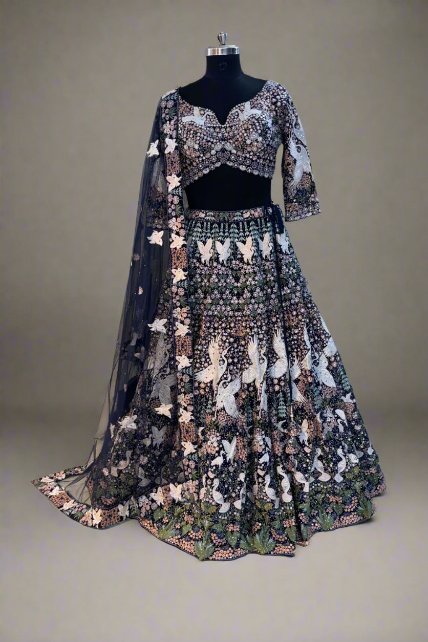 Elegant navy blue net lehenga set with intricate white swan embroidery and floral sequin detailing