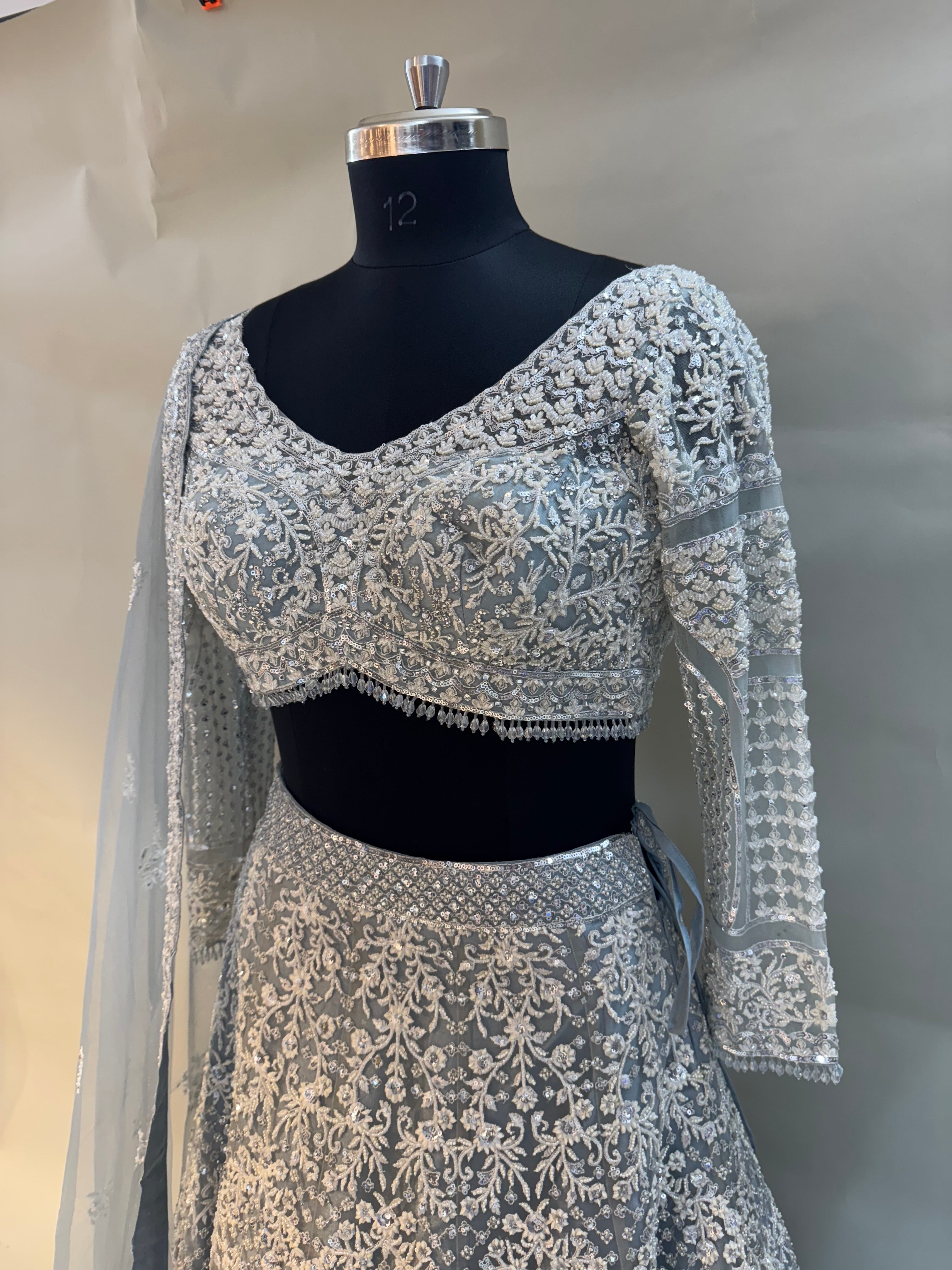 Grace meets glamour in this pastel grey net lehenga