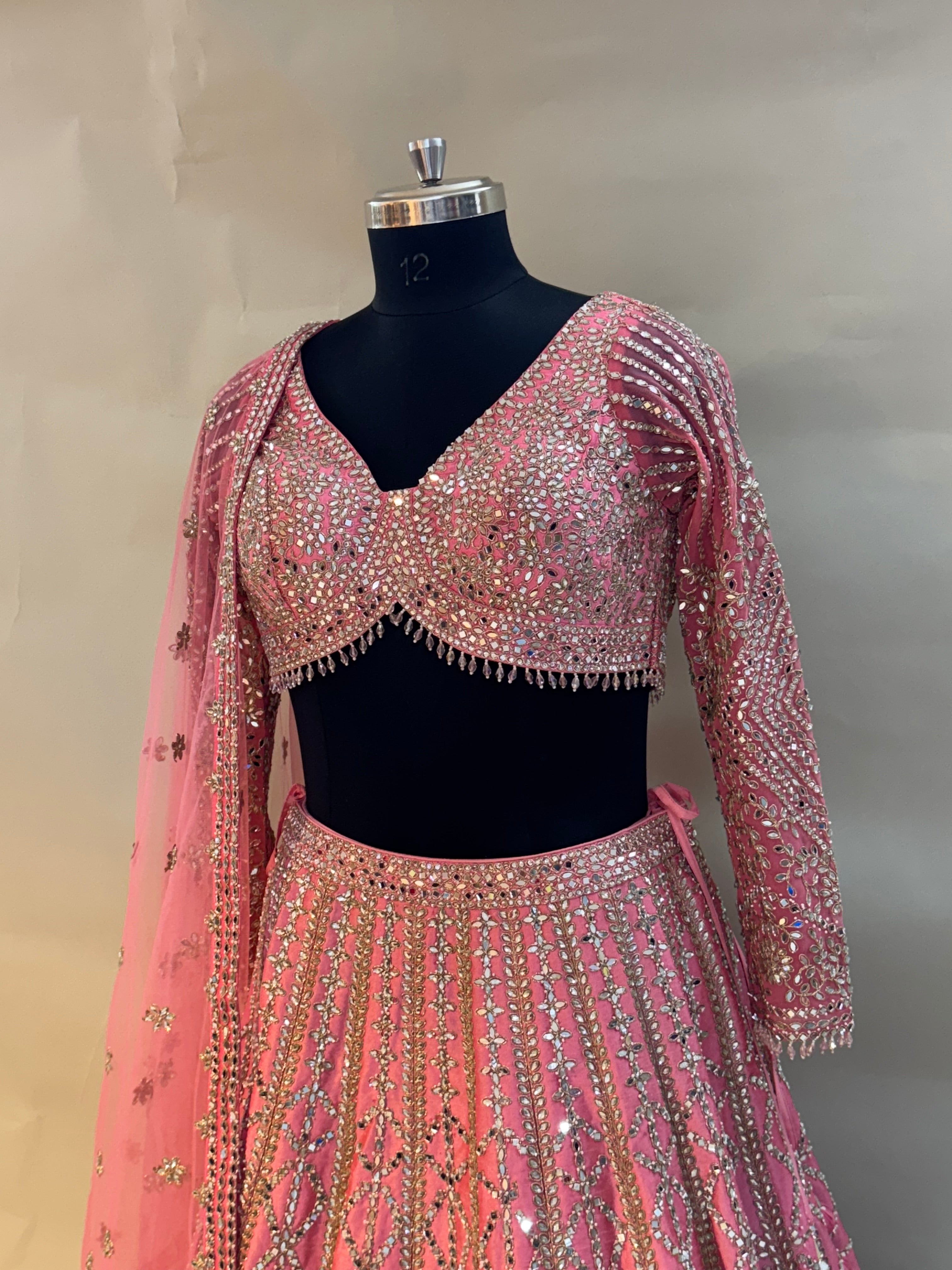 Radiate charm in this vibrant pink lehenga set, crafted in luxurious silk fabric