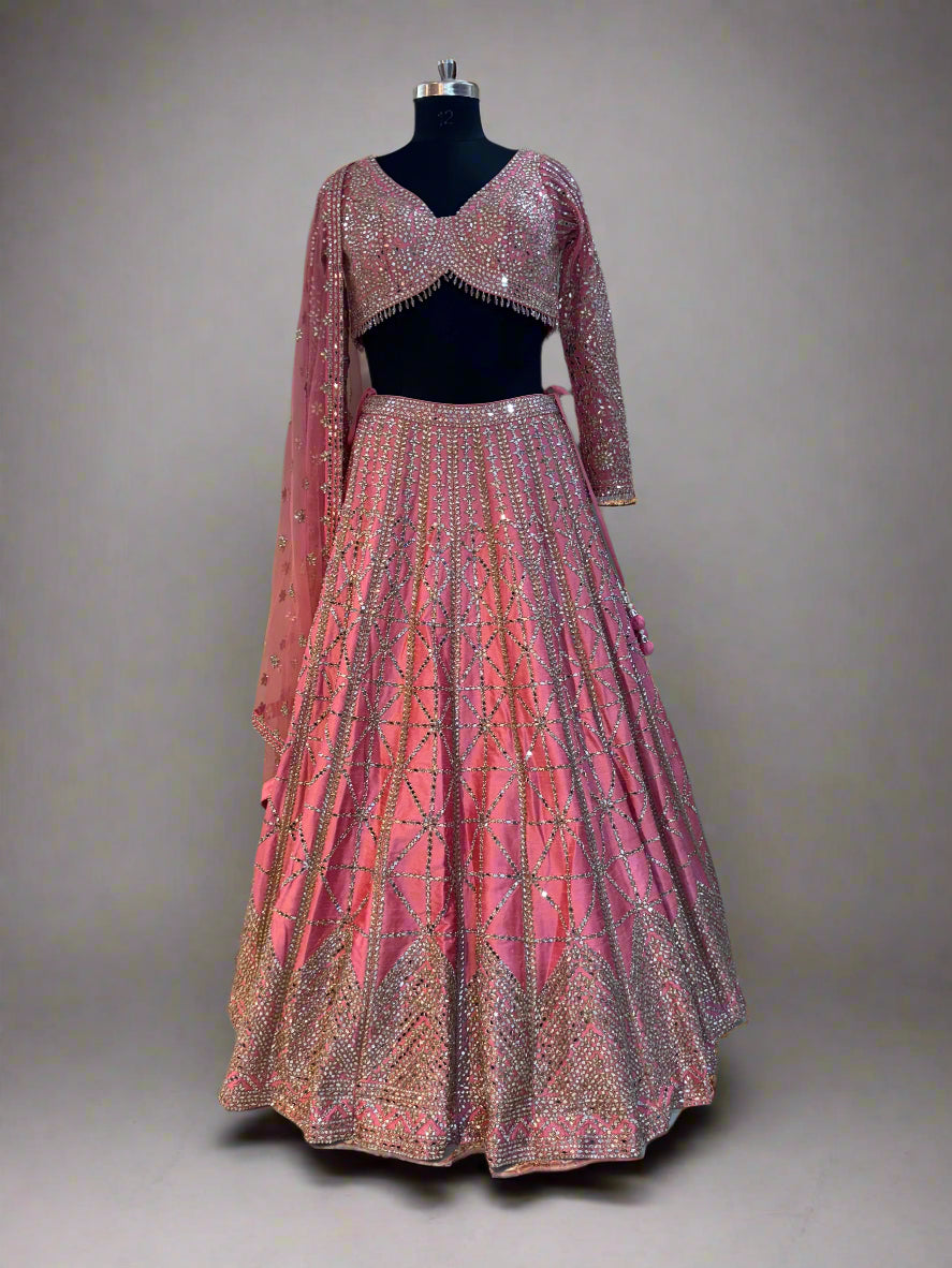 Radiate charm in this vibrant pink lehenga set, crafted in luxurious silk fabric