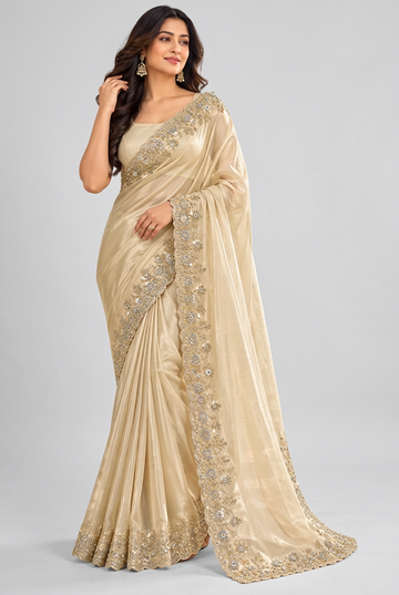 Elegant champagne saree featuring intricate gold embroidery