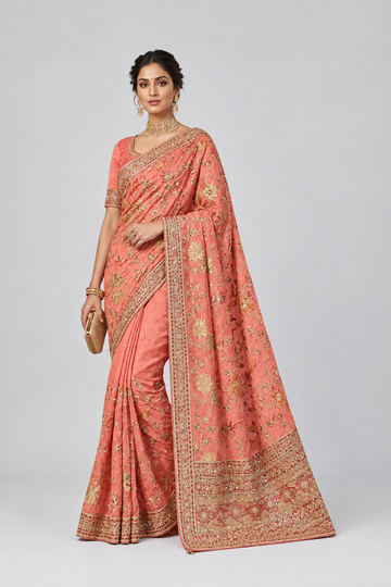 Elegant coral pink saree adorned with intricate golden embroidery