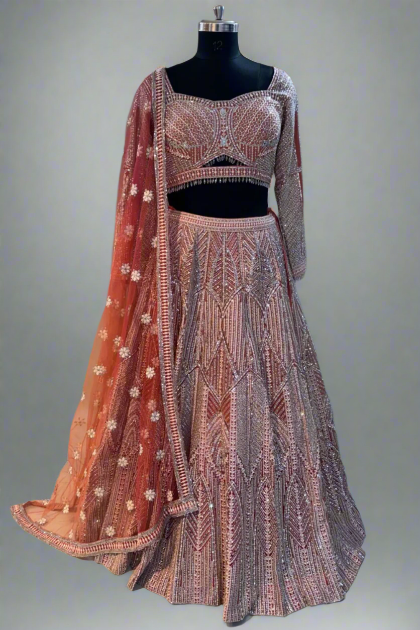 Grace your occasion in this peach-pink shimmer lehenga with intricate geometric sequin and bead embroidery