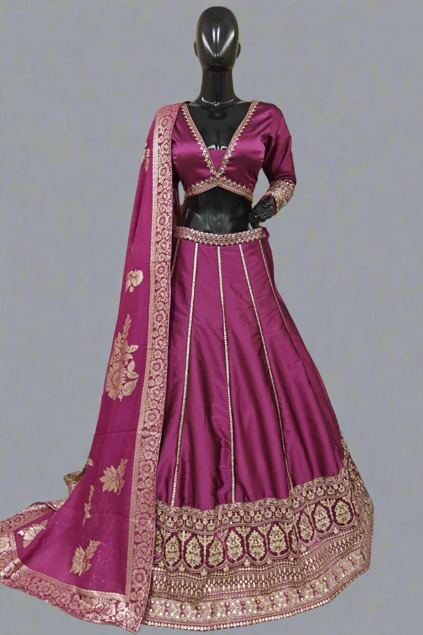 Elegant magenta silk lehenga choli with intricate golden zari and sequin embroidery work