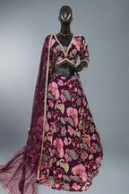Vibrant pink lehenga with bold floral embroidery and a matching dupatta