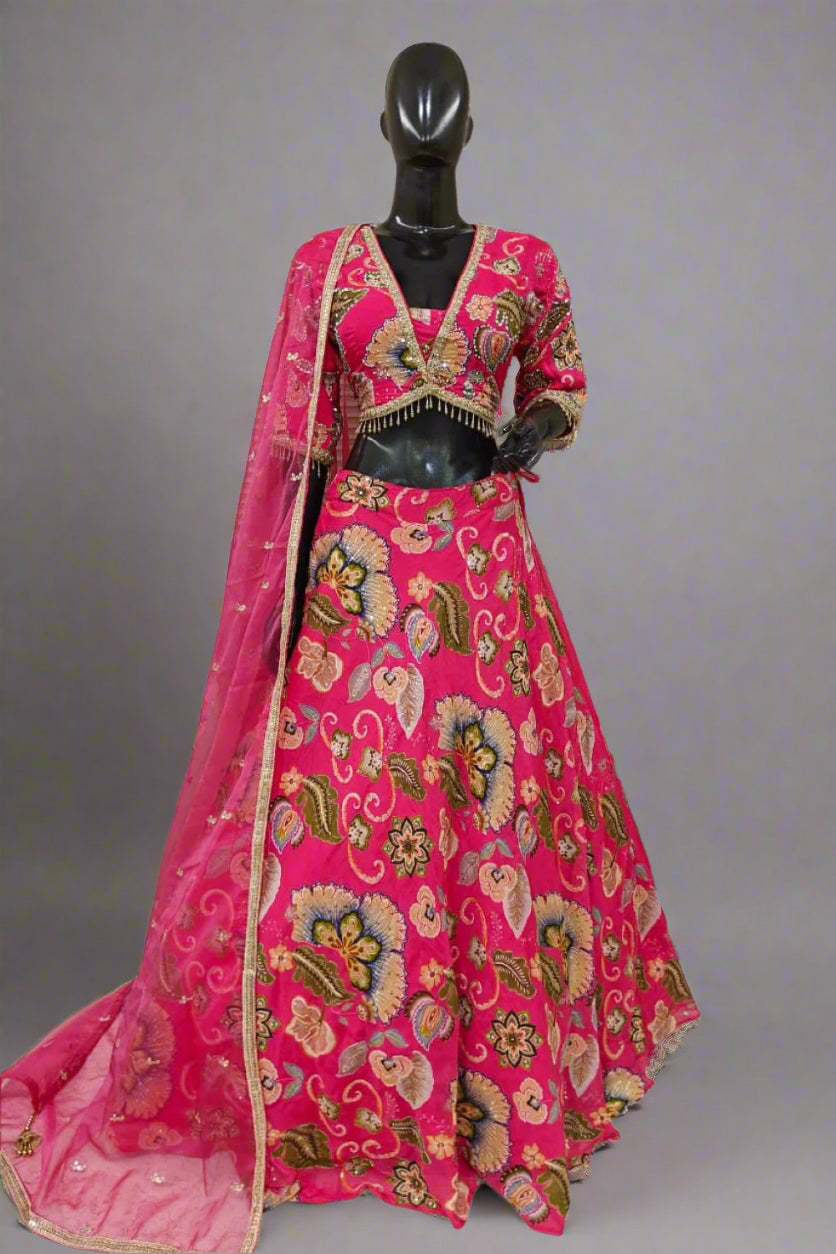 Vibrant pink lehenga with bold floral embroidery and a matching dupatta