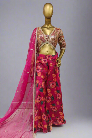 Vibrant ethnic ensemble features a sequin-embroidered blouse and bold floral palazzo