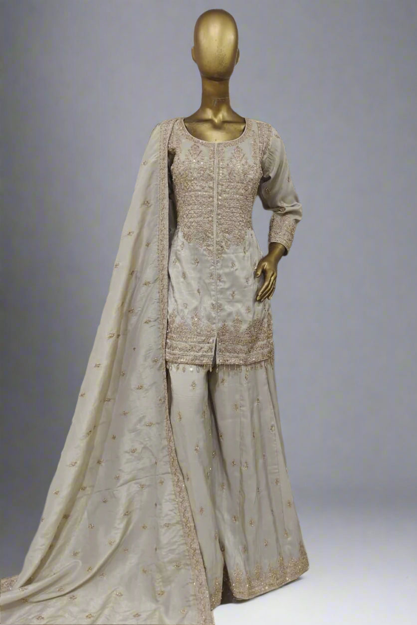 Burnt orange sharara suit adorned with delicate golden embroidery