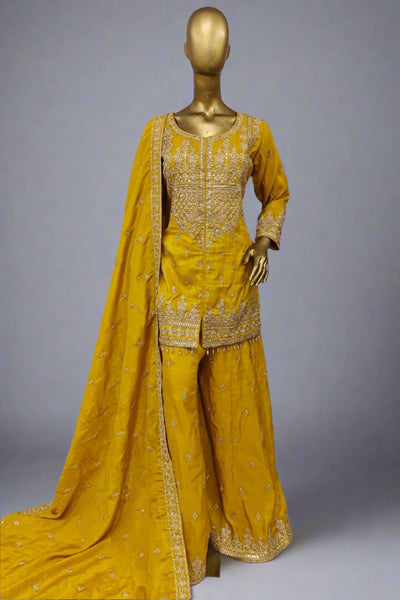 Burnt orange sharara suit adorned with delicate golden embroidery