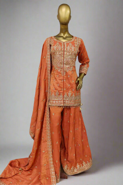 Burnt orange sharara suit adorned with delicate golden embroidery