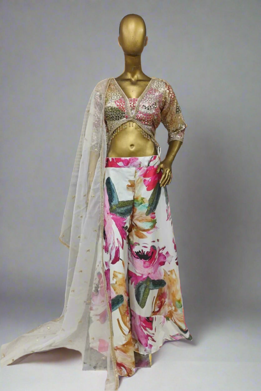 Vibrant ethnic ensemble features a sequin-embroidered blouse and bold floral palazzo