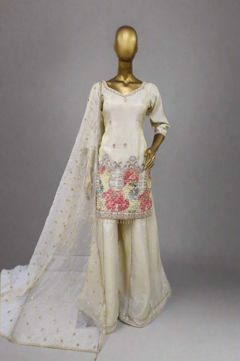 Graceful off-white sharara suit embellished with floral embroidery