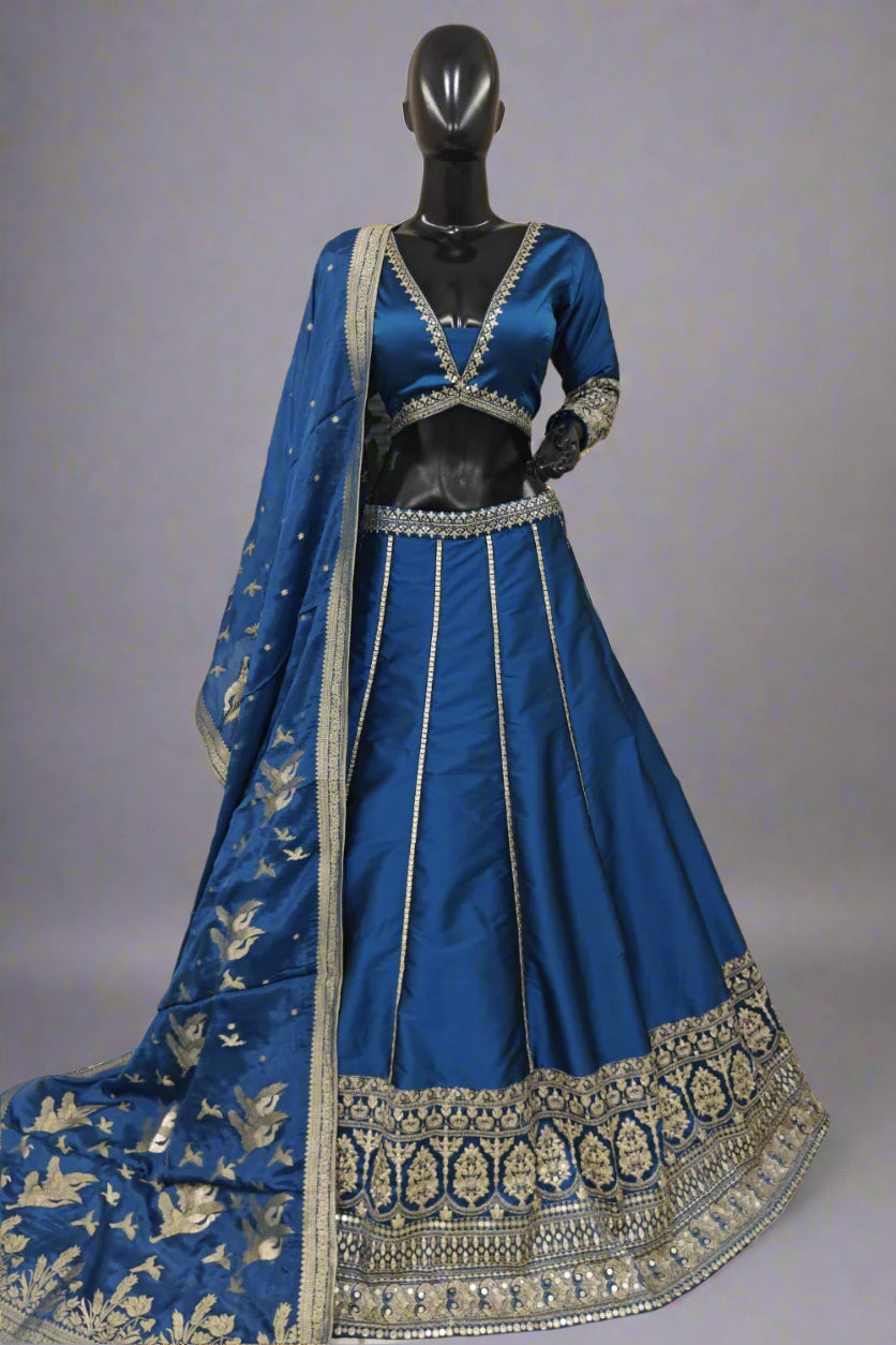 Elegant magenta silk lehenga choli with intricate golden zari and sequin embroidery work