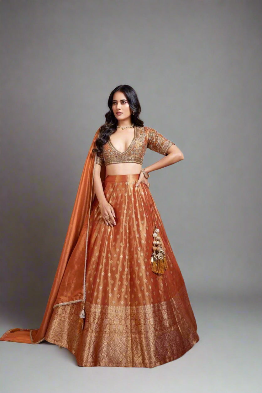 Rust-orange lehenga with intricate zari work