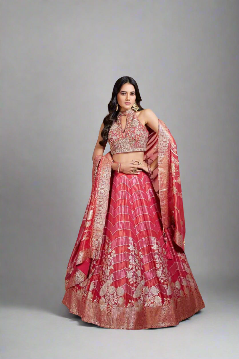 Ruby red lehenga boasts intricate golden zari embroidery and timeless woven elegance.